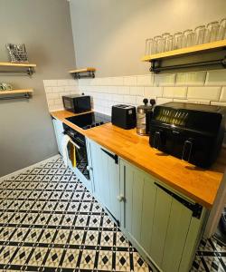 a kitchen with a counter with a toaster oven at Gaen - Ty Seren in Abertillery