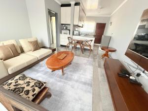 a living room with a couch and a table at The Res Apartments in Maseru