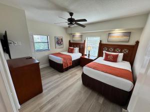 a hotel room with two beds and a ceiling fan at Westgate Lake Resort and Spa ORLANDO in Orlando +22 photos