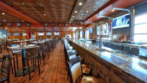 a bar in a restaurant with tables and chairs at Westgate Lake Resort and Spa ORLANDO in Orlando