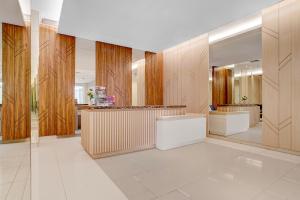 a large lobby with wooden walls and a counter at OYO 94838 Dahoma Tower in Tjikuda Tiga +20 photos
