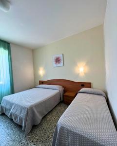 Ένα ή περισσότερα κρεβάτια σε δωμάτιο στο Hotel Valente +43 φωτογραφίες