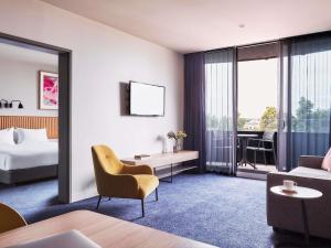 a hotel room with a bed and a couch at Mantra Melbourne Epping in Epping +100 photos