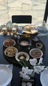 a table with various dishes of food on it at Jabal Hatt Resthouse in Khawr Zammah