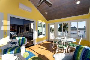 a screened in porch with a table and chairs at A Shore Investment in Edisto Island