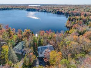 an aerial view of a house on a lake at Tranquil Waters Kayaks Firepit Lakefront in Pocono Summit