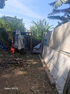 a fence with a gate in a yard at Camping - Recanto do Leâo in Guarujá +1 photo