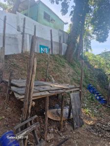 a wooden table sitting on top of a hill at Camping - Recanto do Leâo in Guarujá