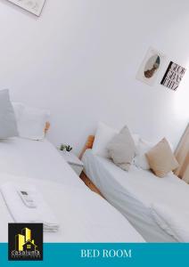two beds in a room with white sheets and pillows at CASA SOUL & SOFT 2Bedroom-2Bathroom AT TRION-KL in Kuala Lumpur