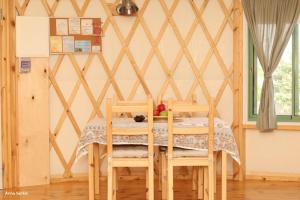 a dining room with a table and chairs at היורט על הגג - צוקים in Zuqim +23 photos