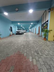 a large room with two cars parked in it at Hotel Saai Residency in Tiruvannāmalai