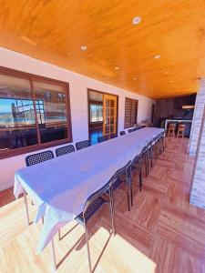 a large long table in a room with chairs at Quillon Cabaña Privada Vista al Valle in Quillón