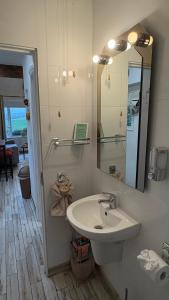 a bathroom with a sink and a mirror at The Casan in Letterkenny