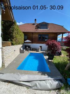 a swimming pool in the backyard of a house at Apartment „AlpView“,Tirol mit Sauna und Pool in Vomp