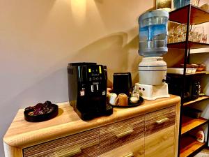 a coffee maker on top of a wooden counter at Traditional Narva House - Triumvirate 6 in Narva +28 photos