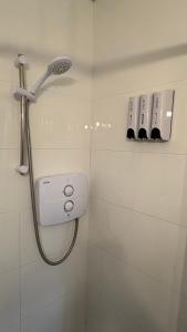 a shower with a shower head in a bathroom at The Casan in Letterkenny