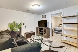 a living room with a couch and a tv at Less Than 2 Mi to UMass Health and Dtwn Traveling Pros Hub in Worcester
