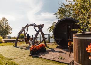 a sculpture of a monkey in front of a building at Waterfront Glamping - Private hot tube, sauna & sunset view in Wapnica