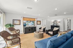 a living room with a blue couch and chairs at Sandcastle Suite - 632C in Siesta Key
