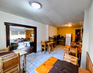 a kitchen and dining room with wooden tables and chairs at B&B Copahue in San Carlos de Bariloche