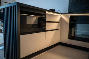a kitchen with a black and white stove at Adora Park Exclusive Stay in Arad
