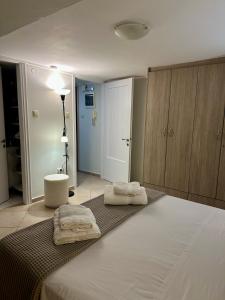 a bedroom with a bed with two towels on it at Adrianas Central Stay in Patra