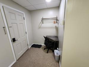 a hallway with a door and a desk in a room at Dunnstown Lodge in Lock Haven +1 photo