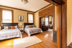 a bedroom with two beds and a living room at Historic Midtown Apartment in Memphis