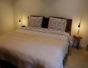 a bedroom with a large bed with two pillows at In de olde kapschuur in Beemte