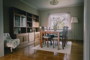 a dining room with a wooden table and chairs at Nature stay, near the city in Hjorten +18 photos