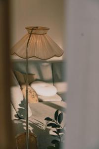 a lamp sitting next to a bed with pillows at Nature stay, near the city in Hjorten