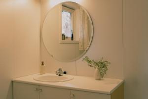 a bathroom with a sink and a mirror at Nature stay, near the city in Hjorten