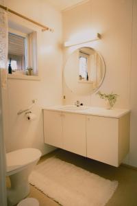 a bathroom with a white sink and a mirror at Nature stay, near the city in Hjorten