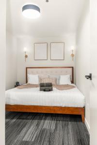 a bedroom with a large bed with a wooden frame at 2BR in Downtown with Parking in Spokane