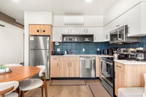 a kitchen with wooden cabinets and stainless steel appliances at 2BR in Downtown with Parking in Spokane +30 photos
