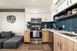 a kitchen with white cabinets and a stove top oven at 2BR Apartment in DT with Parking in Spokane