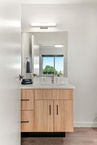 a bathroom with a sink and a mirror at 2BR Apartment in DT with Parking in Spokane