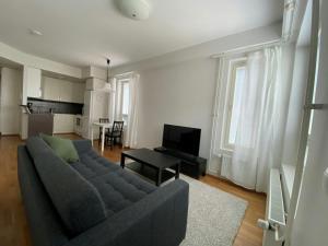 a living room with a couch and a table at Convenient Apartment for 2 with Sauna in Kemi