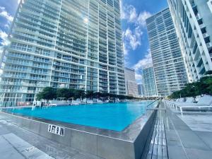 a large swimming pool in a city with tall buildings at GORGEOUS VIEWS Luxury Miami Brickell Pool Gym Spa in Miami