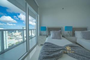 a bedroom with a bed and a large window at GORGEOUS VIEWS Luxury Miami Brickell Pool Gym Spa in Miami +27 photos