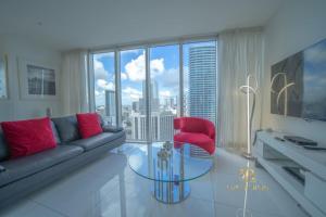 a living room with a couch and a red chair at W Miami - LUXURY condo Amazing Views in Miami