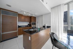 a kitchen with wooden cabinets and a counter top at W Miami - LUXURY condo Amazing Views in Miami