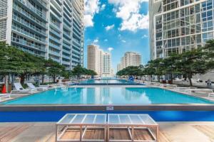 a large swimming pool in a city with tall buildings at W Miami - LUXURY condo Amazing Views in Miami