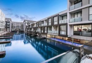 a swimming pool in the middle of a building at QV Stays Viaduct Harbour Elegance in Auckland