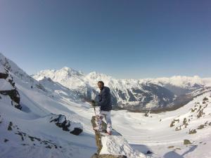 a man standing on top of a snow covered mountain at Arpege Des Neiges in Sainte-Foy-Tarentaise