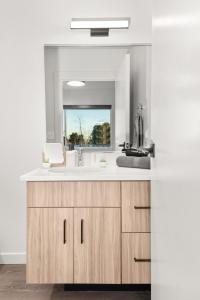 a bathroom with a sink and a mirror at DT 2br 2bath Modern Apartment in Spokane