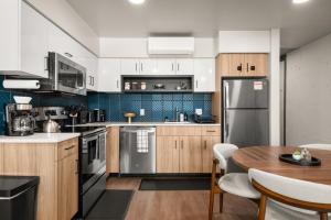 a kitchen with wooden cabinets and a table with a dining room at DT 2br 2bath Apartment in Spokane