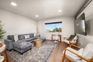 a living room with a couch and a tv at DT 2br 2bath Apartment in Spokane