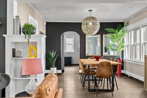 a dining room with a table and chairs at Roomy Central Hub, Games, Fire Pit & Downtown Fun in Oshkosh