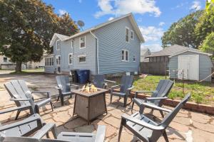 a patio with chairs and a table with a fire pit at Roomy Central Hub, Games, Fire Pit & Downtown Fun in Oshkosh